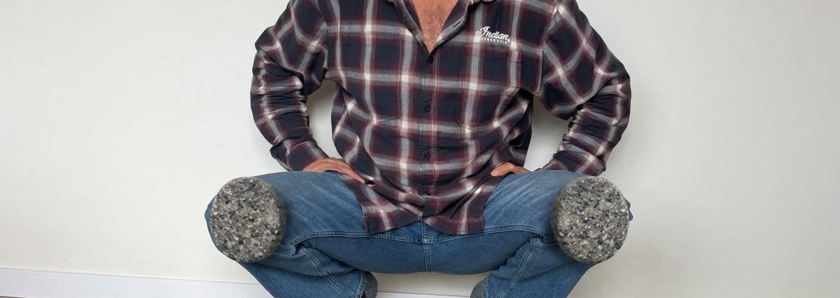 A tradesman crouching with recycled-foam Z-Pads stuck to the knees of his jeans
